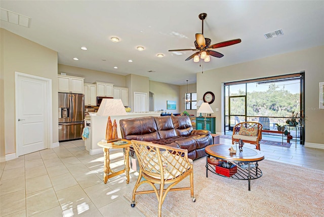 living room with light tile flooring and ceiling fan