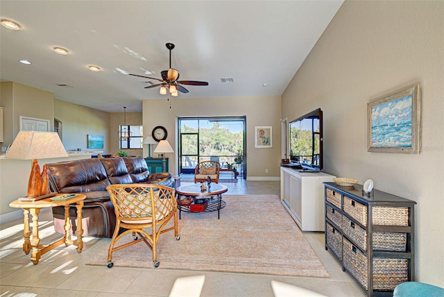 living room with light tile floors and ceiling fan