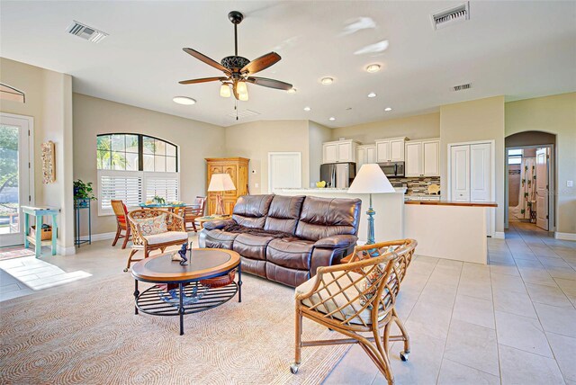 tiled living room with ceiling fan