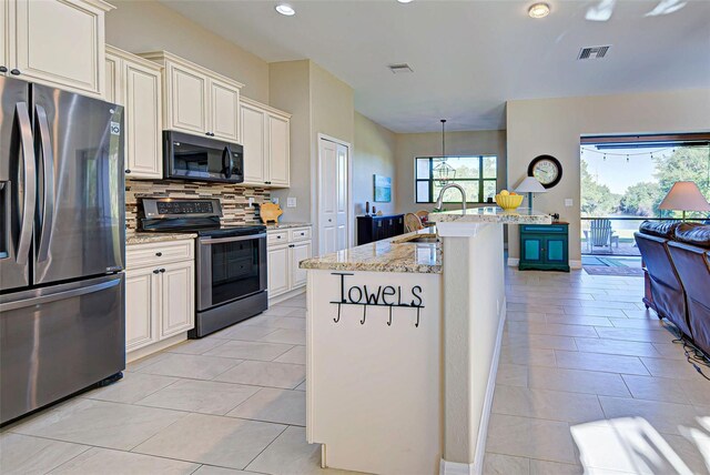 kitchen featuring range with electric cooktop, tasteful backsplash, sink, stainless steel refrigerator with ice dispenser, and light stone counters