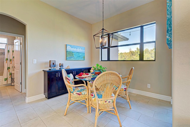 dining area featuring a notable chandelier and light tile floors