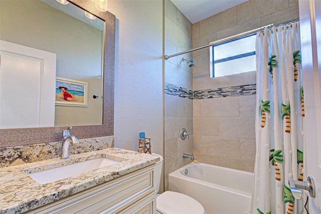 full bathroom featuring vanity, shower / bath combo with shower curtain, and toilet