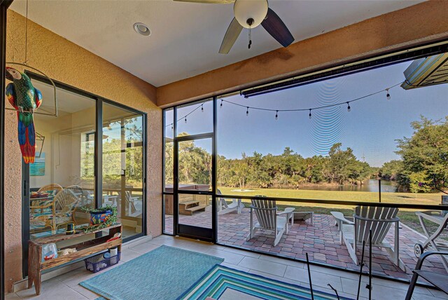 sunroom / solarium featuring ceiling fan