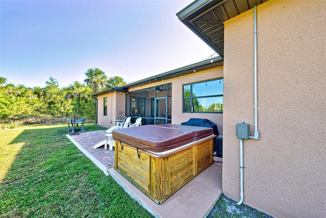 view of yard with a patio and a hot tub