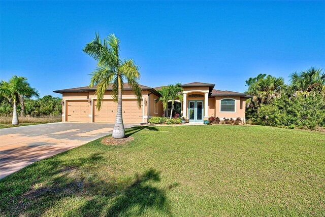 view of front of property featuring a front lawn and a garage