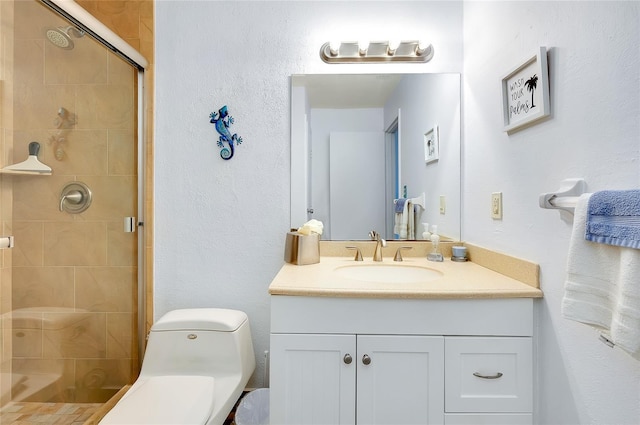 bathroom with oversized vanity, toilet, and a shower with shower door