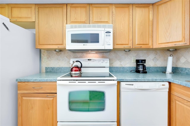 kitchen with backsplash and white appliances