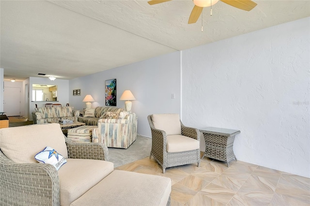 living room featuring a textured ceiling and ceiling fan