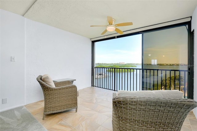 interior space with ceiling fan