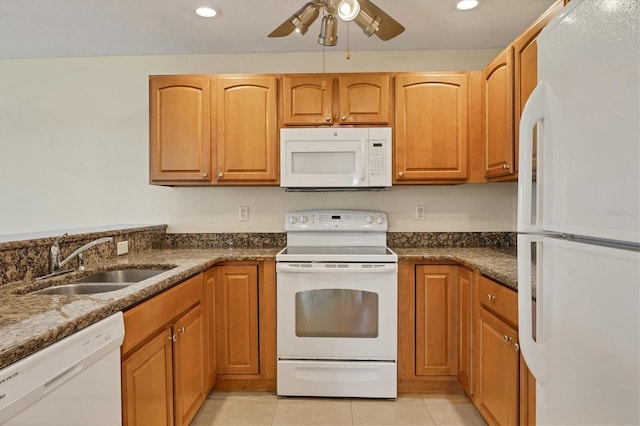 kitchen with ceiling fan, light tile flooring, white appliances, sink, and dark stone counters