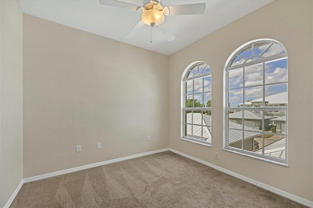 spare room with carpet floors and ceiling fan