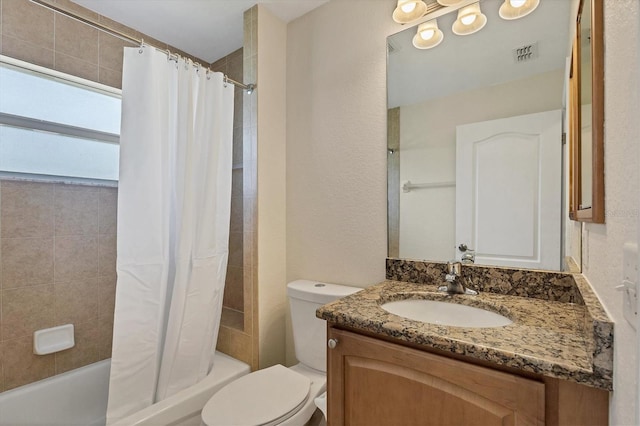 full bathroom with shower / bath combo, vanity with extensive cabinet space, and toilet