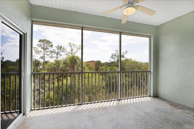 unfurnished sunroom with plenty of natural light and ceiling fan