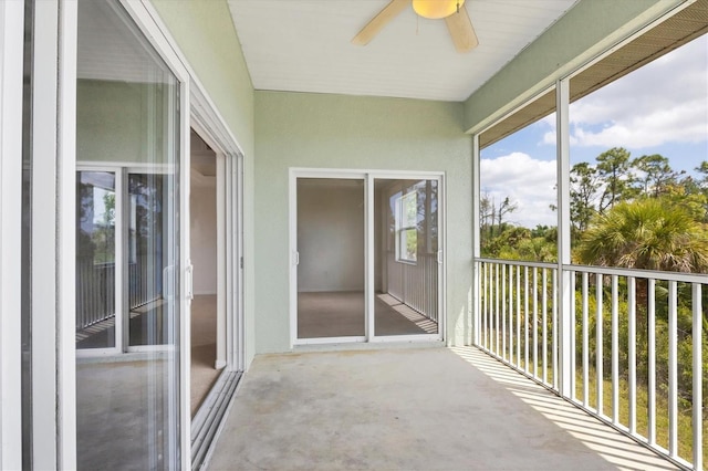 unfurnished sunroom featuring ceiling fan