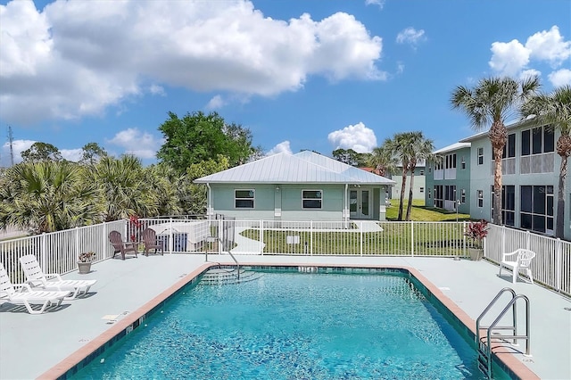 view of swimming pool featuring a yard and a patio area