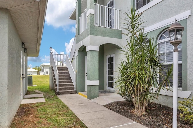 view of exterior entry featuring a balcony