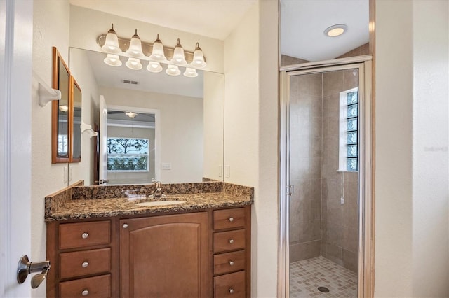 bathroom with an enclosed shower and vanity with extensive cabinet space