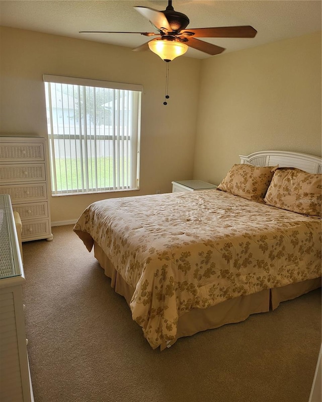 bedroom featuring ceiling fan and carpet