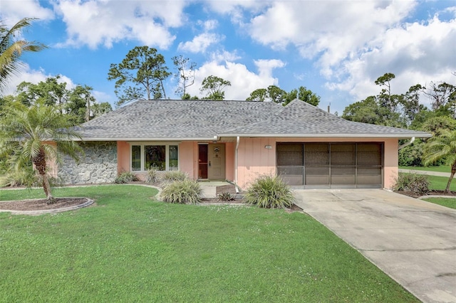 ranch-style home with a garage and a front lawn