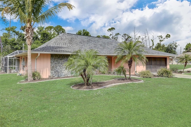 ranch-style home featuring a garage and a front lawn