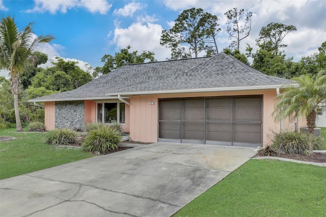 ranch-style house featuring a garage and a front yard