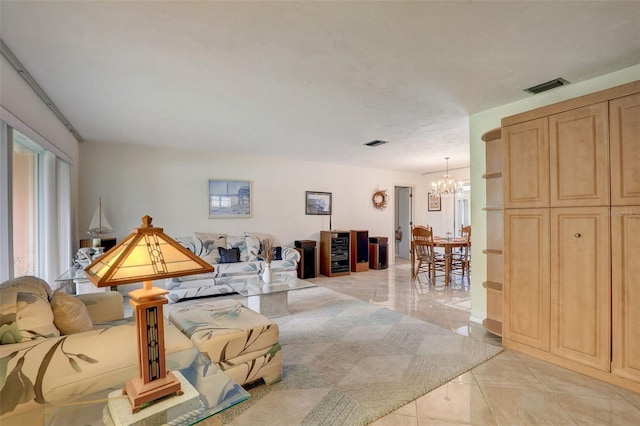 living room with light tile patterned flooring and a chandelier