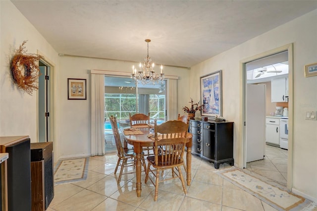 tiled dining room with a chandelier