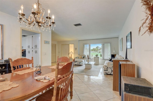 tiled dining area with a notable chandelier