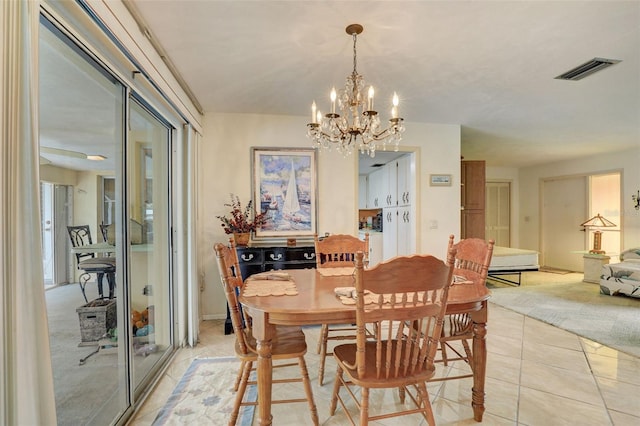 tiled dining area featuring a notable chandelier