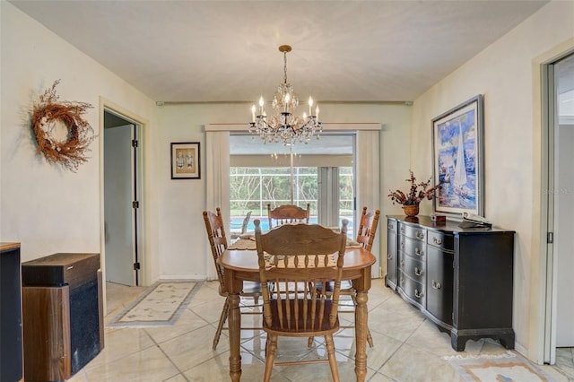 tiled dining room with an inviting chandelier