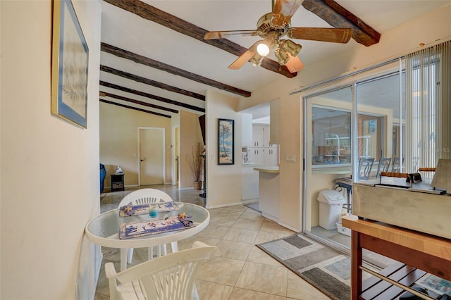 interior space with light tile patterned floors, plenty of natural light, ceiling fan, and vaulted ceiling with beams