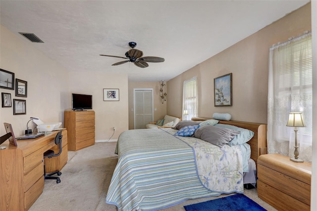 carpeted bedroom featuring a closet and ceiling fan