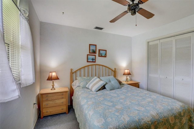 carpeted bedroom with a closet and ceiling fan