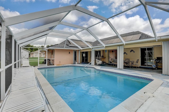 view of swimming pool with a patio and glass enclosure