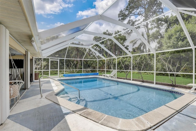 view of swimming pool featuring a lanai and a patio area