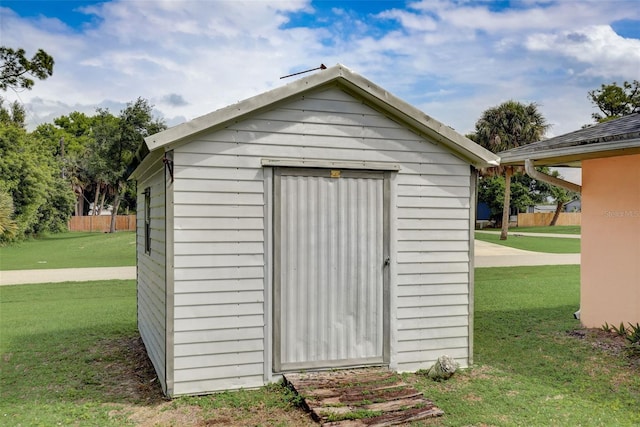 view of outbuilding with a yard