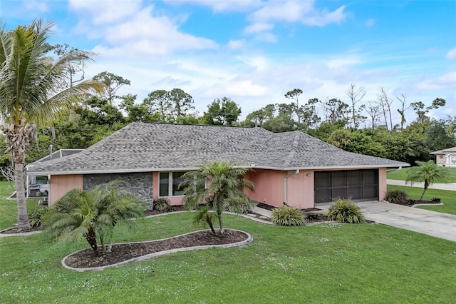 ranch-style home with a garage and a front lawn