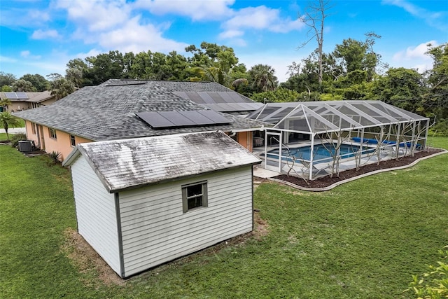 exterior space featuring a lanai, cooling unit, and a yard