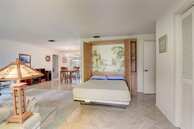 tiled bedroom with a chandelier