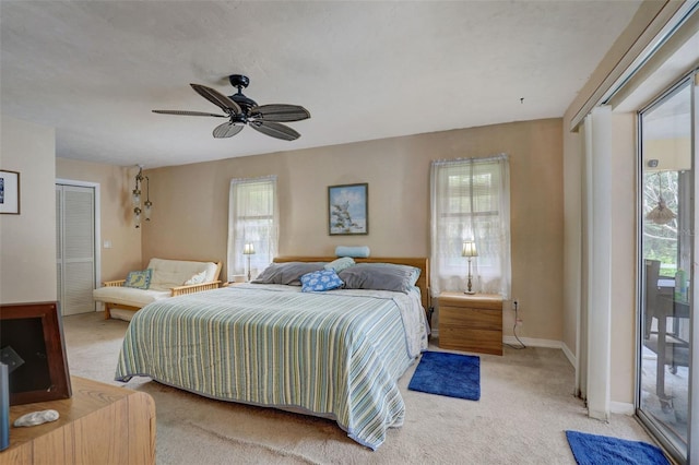 carpeted bedroom featuring access to outside, multiple windows, a closet, and ceiling fan