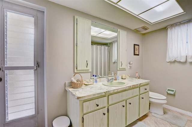 bathroom featuring vanity, toilet, and tile patterned floors