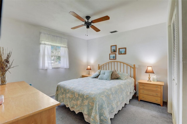 carpeted bedroom featuring ceiling fan and a closet