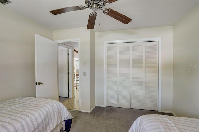 carpeted bedroom with a closet and ceiling fan