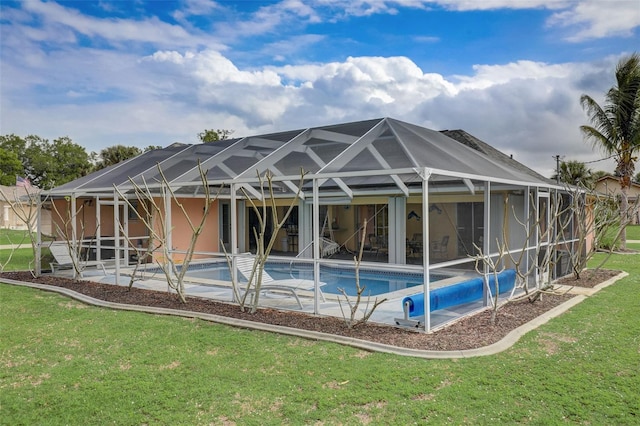 rear view of property with a lanai, a patio, and a yard