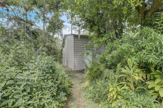 view of side of property with a storage shed