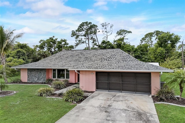 single story home with a garage and a front lawn