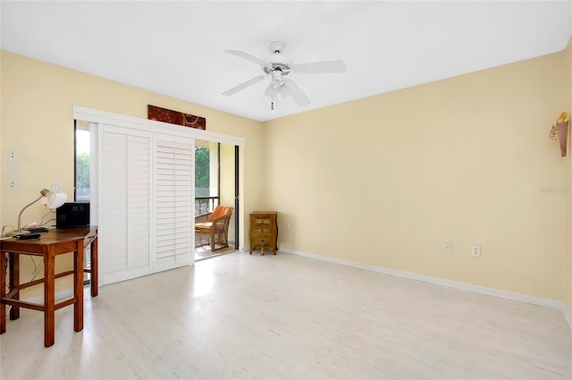 empty room featuring ceiling fan, light hardwood / wood-style flooring, and a wealth of natural light