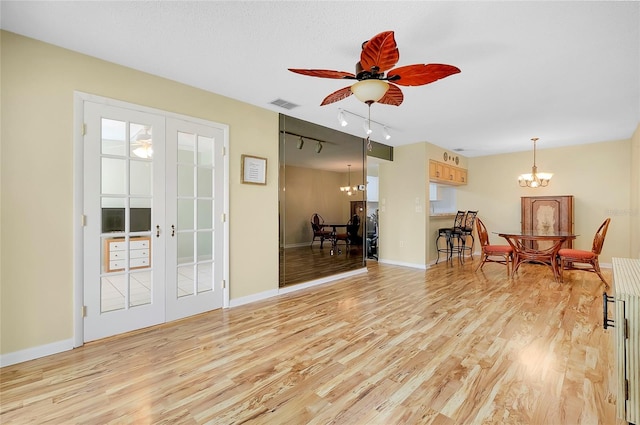 sitting room with light wood-type flooring, visible vents, and french doors