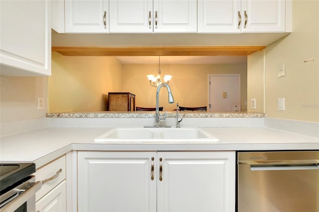 kitchen featuring white cabinetry, light countertops, appliances with stainless steel finishes, and a sink