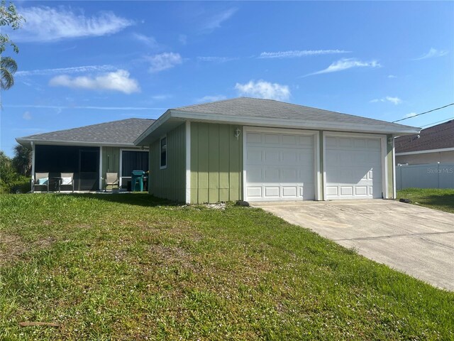 ranch-style house featuring a front lawn and a garage